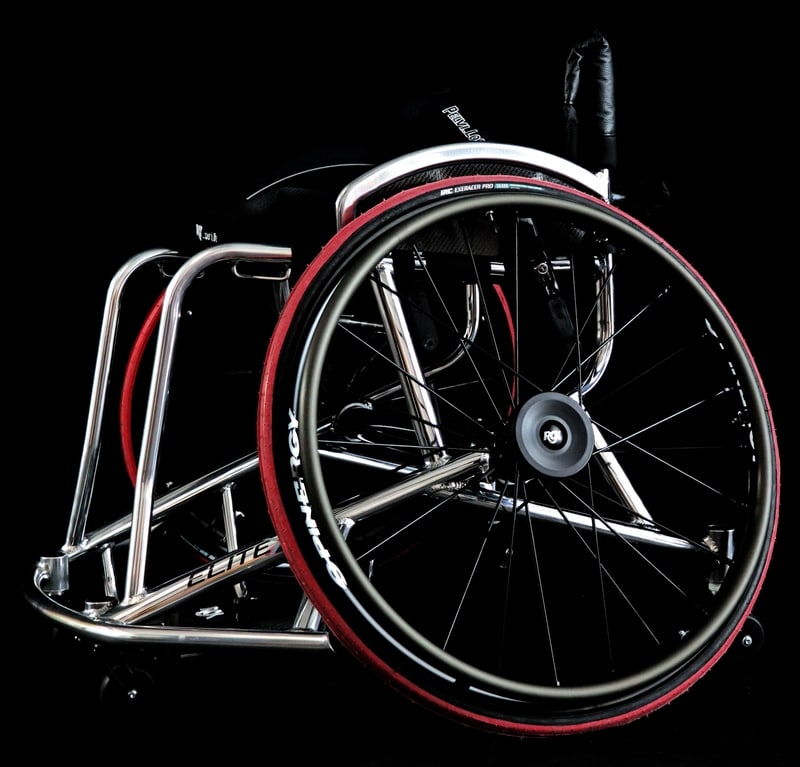 Wheelchair with red wheels on a black background rgk elite x