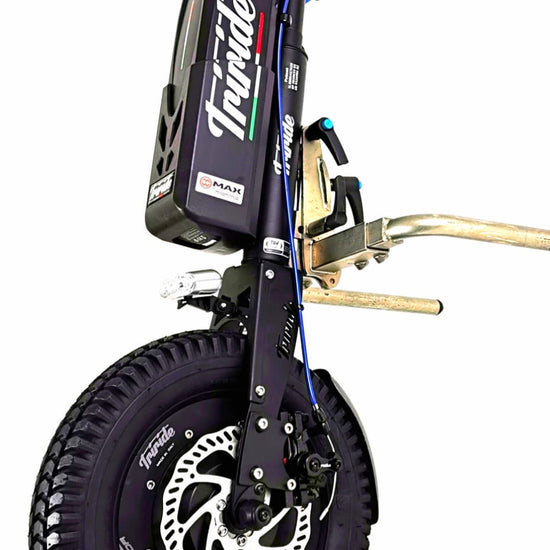 Triride Special Compact High Torque HT All Road wheelchair power attachment in the snow with sled behind
