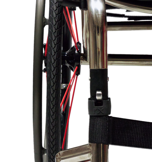 Close-up of a wheelchair wheel assembly fx rgk folding with a black tire, red spokes, a black seat belt attached to a chrome frame, and a black plastic buckle labeled FX.
