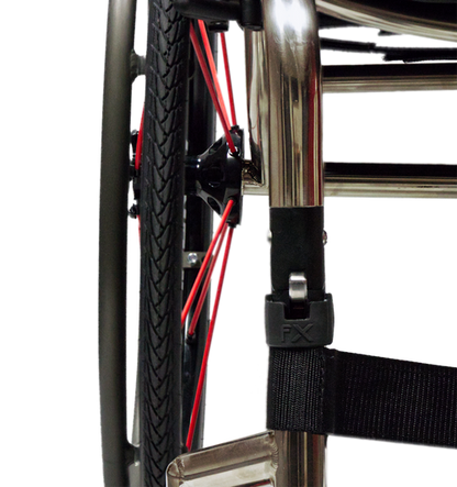 Close-up of a wheelchair wheel assembly fx rgk folding with a black tire, red spokes, a black seat belt attached to a chrome frame, and a black plastic buckle labeled FX.